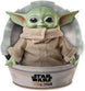 Photo de la peluche Yoda The Child tenue dans une main pour taille