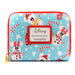 Portefeuille Loungefly Disney posé sur une surface blanche avec un fond hivernal flou.