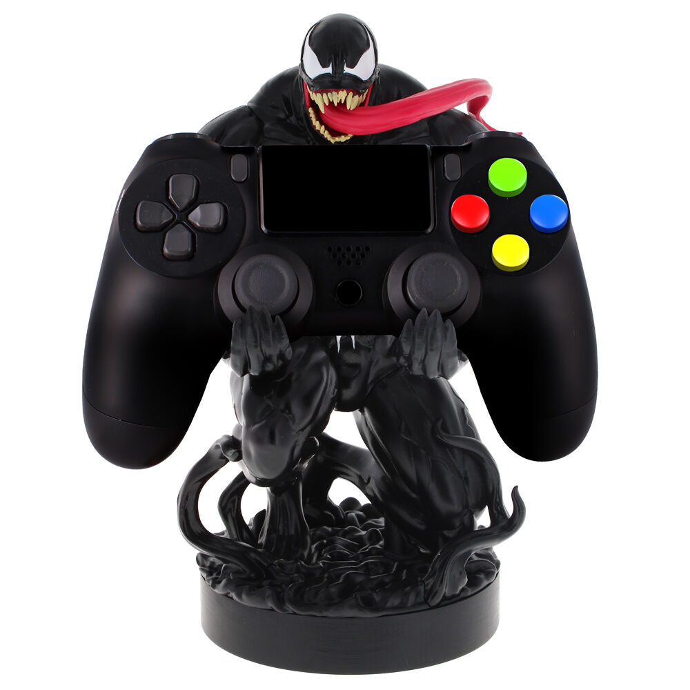 Image du support Venom avec plusieurs accessoires de jeu autour sur un bureau