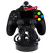 Image du support Venom avec plusieurs accessoires de jeu autour sur un bureau