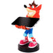 Support de charge Crash Bandicoot avec un smartphone iPhone posé dessus, montrant la compatibilité universelle