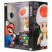 Photo rapprochée des pieds et de la base de la figurine Toad Super Mario Bros
