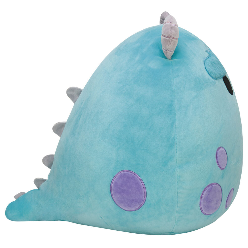 Peluche Sulley Squishmallows Monster Inc posée sur un canapé clair