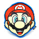 Coussin 3D Super Mario Bros Mario posé sur un canapé dans un salon décoré avec des éléments gaming