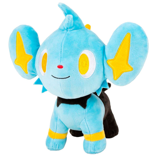 Peluche Shinx assise sur un fond blanc, illustrant sa taille et sa texture douce