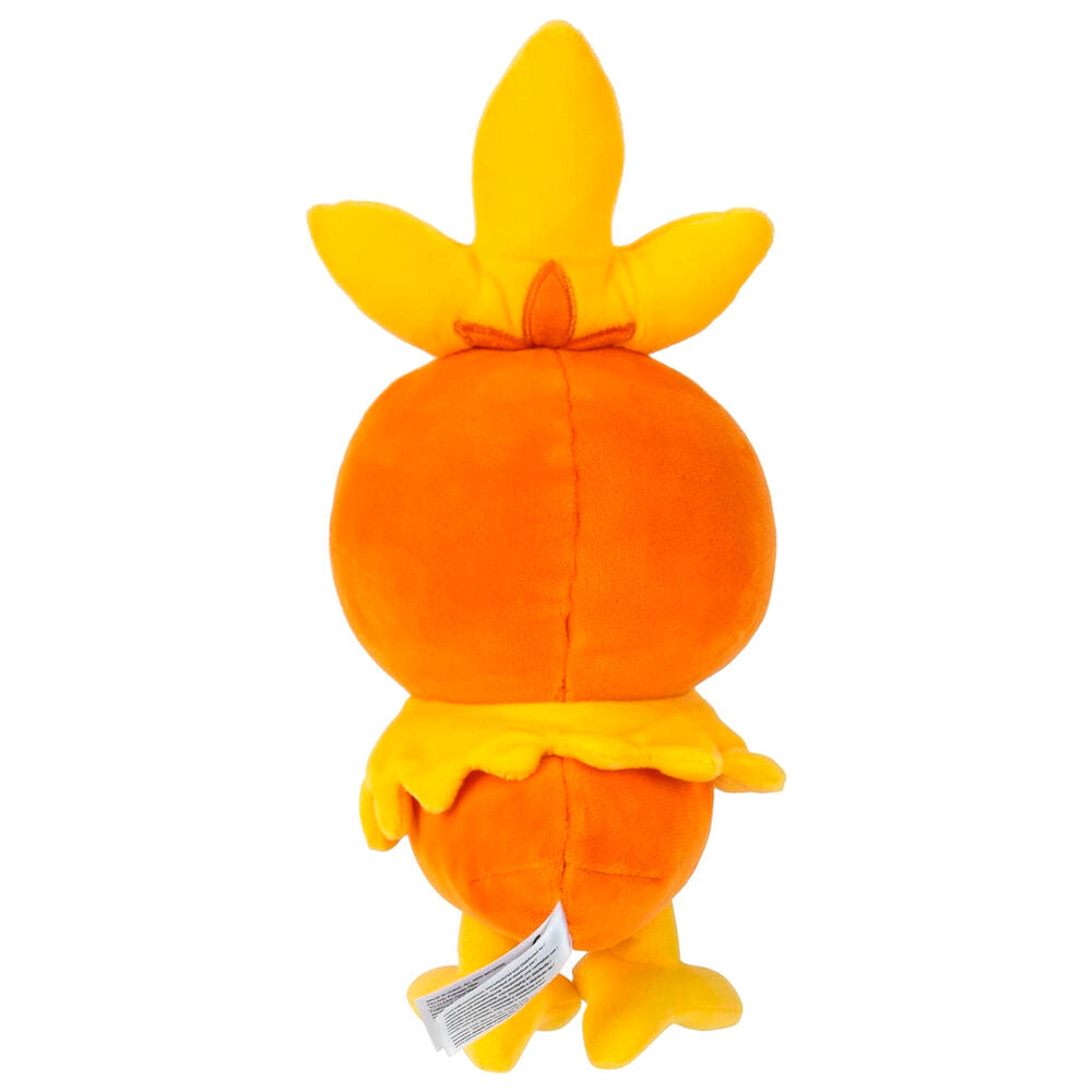 Peluche Torchic assise montrant son expression joyeuse et ses pattes en peluche