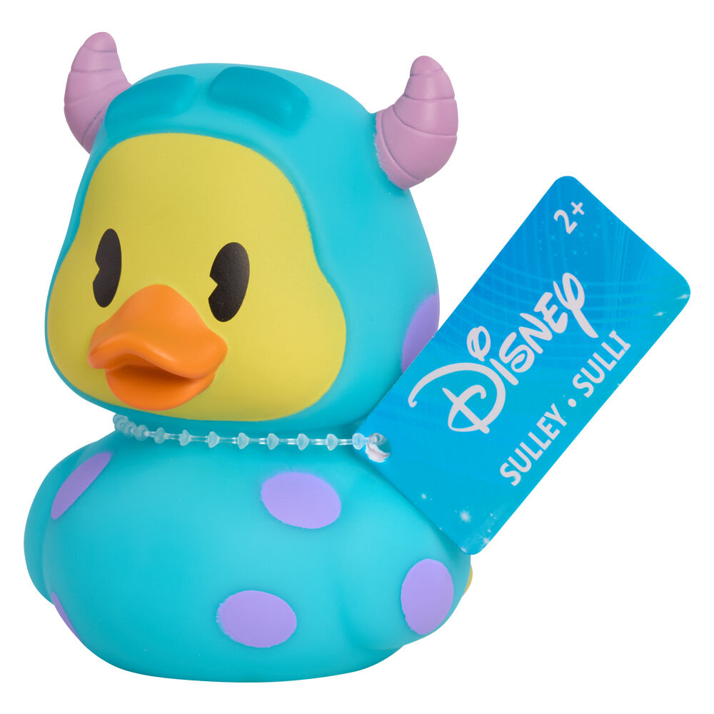 Canard en caoutchouc Disney rose avec robe à pois blancs, posé sur surface lisse