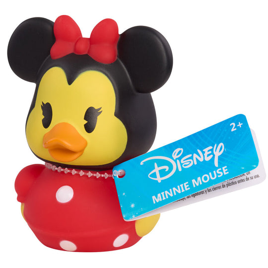 Canard en caoutchouc Disney blanc avec nœud papillon rouge, posé sur table en bois