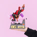 Calendrier Deadpool Marvel posé sur un bureau décoré avec accessoires geek
