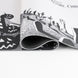 Image montrant les bords renforcés et cousus du tapis gaming Disney Nightmare Before Christmas
