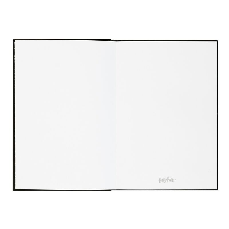 Photo du cahier Lumos Harry Potter allumé, illuminant la couverture douce au toucher