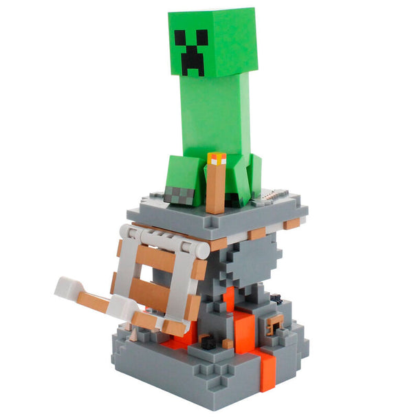 Vue rapprochée du support Minecraft Creeper tenant un smartphone iPhone en charge
