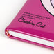 Vue rapprochée du sourire du Cheshire sur la couverture du cahier CERDÁ