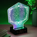 Lampe Elphaba Wicked en acrylique transparente allumée sur une table moderne