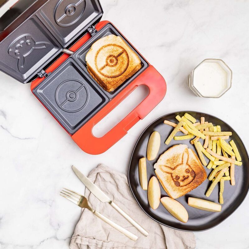 Presse à sandwich Pokémon ouverte montrant la plaque chauffante et le design Pokéball