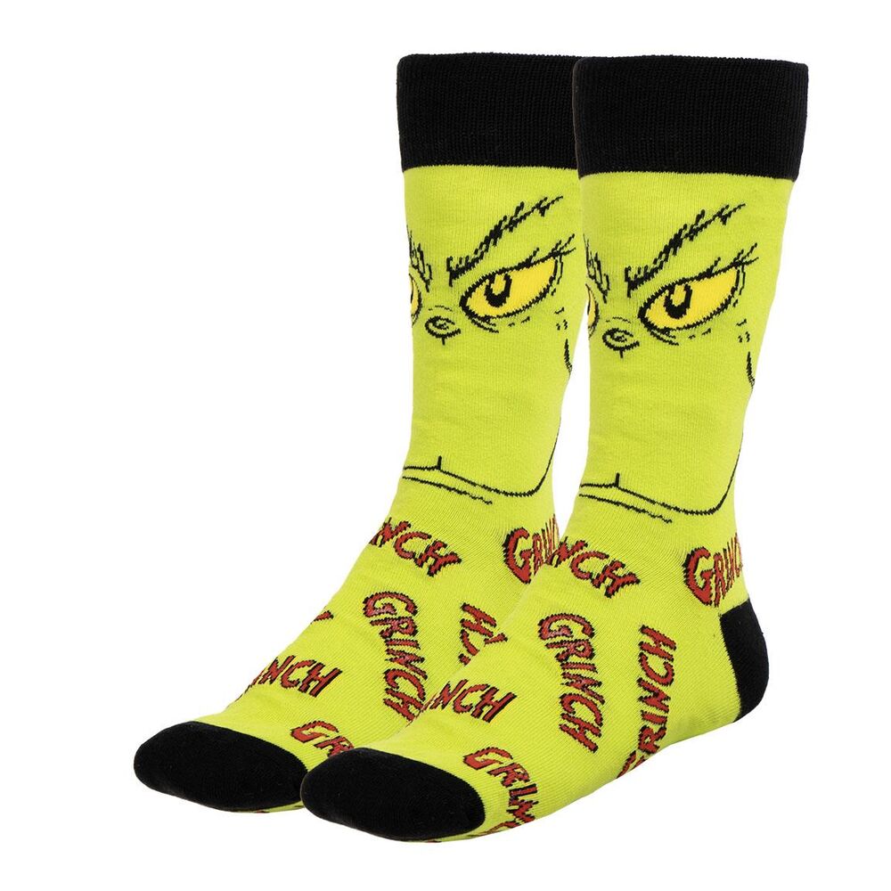 Détail du motif Grinch coloré sur une chaussette adulte, parfait pour les fans du personnage