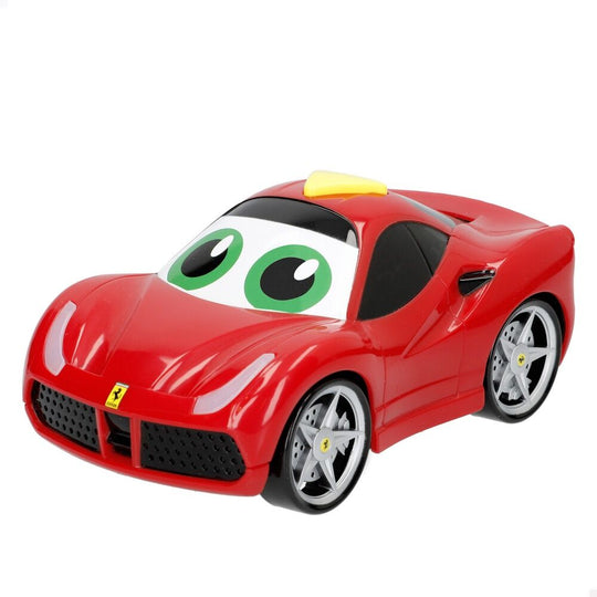 Voiture junior Ferrari BURAGO rouge avec éclairage avant allumé sur fond blanc