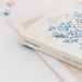 Album photo posé sur une table avec accessoires de scrapbooking à côté