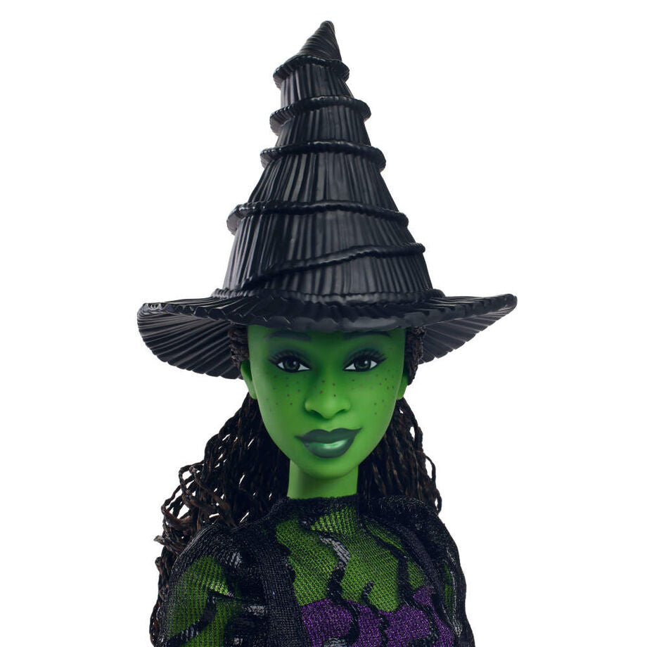 Poupée Elphaba Thropp posée avec accessoires et tenue fidèle au personnage du film Wicked