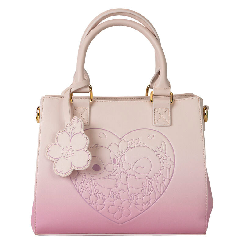 Zoom sur la fermeture zippée dorée et la robustesse de la poignée supérieure du sac Stitch