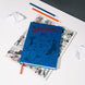 Cahier Superman A5 ouvert exposant la qualité des feuilles lignées et la reliure solide