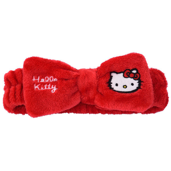 Bandeau Hello Kitty rose de la marque TAKE CARE posé sur un fond blanc avec un design mignon