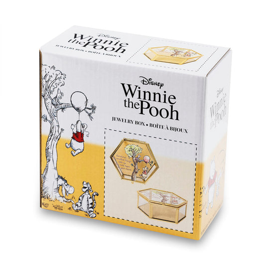 Détail du design texte et illustration de Winnie l'Ourson sur la boîte à bijoux dorée