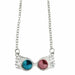 Collier Harry Potter Luna Lovegood avec pendentif lunettes ornées de cristaux bleus et roses sur fond blanc