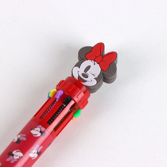 Stylo Minnie posé sur un carnet avec ses couleurs vives et design ludique