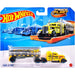 Camion Hot Wheels avec remorque en métal sur une piste Hot Wheels, prêt pour la course