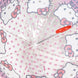 Parapluie Hello Kitty posé sur une surface blanche, montrant le design complet