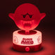 Lampe Boo Super Mario à côté d'une console de jeu, créant une ambiance immersive.